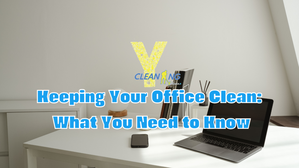 An office desk with a clean, organized workspace featuring a computer, notepads, and plants to promote productivity and a positive work environment.