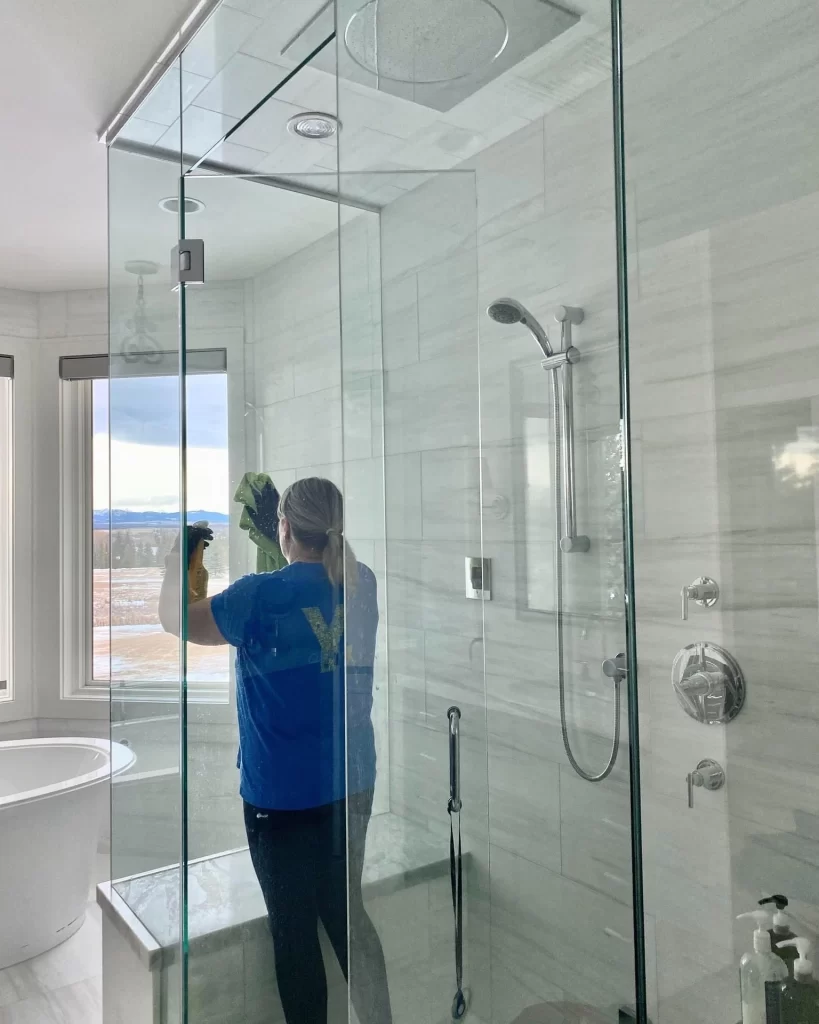 YCleaning: Professional Cleaner Ensuring Sparkling Washroom Glass in Calgary, Exemplifying Expertise and Precision in Cleaning Services.