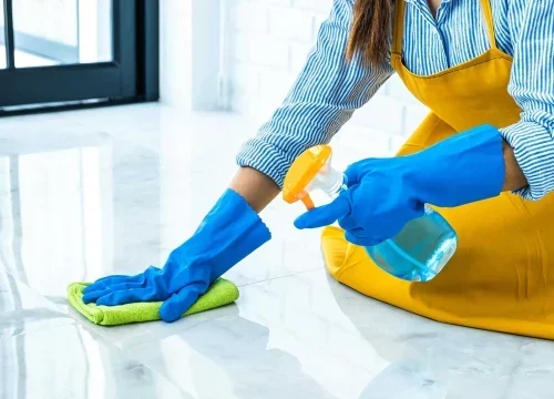 Professional cleaner using spray on floor in Calgary